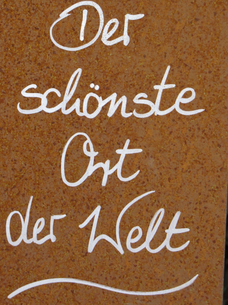 Edelrost Spruchschild Der schönste Ort der Welt Wandtafel Metallschild Garten